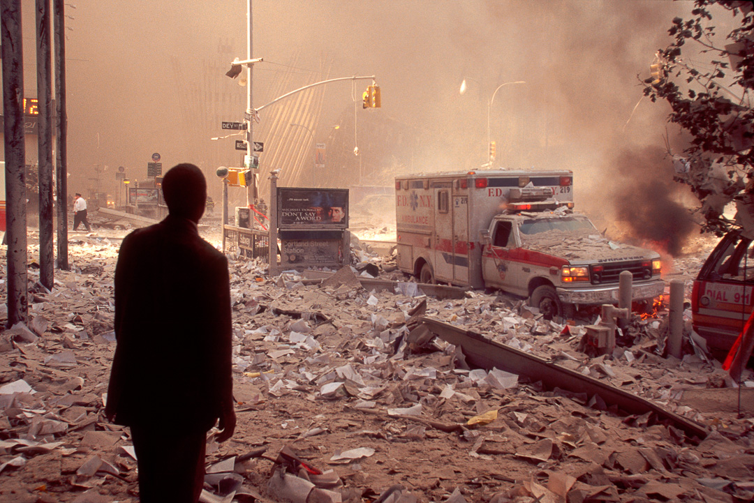 A survivor stares in disbelief at the WTC destruction