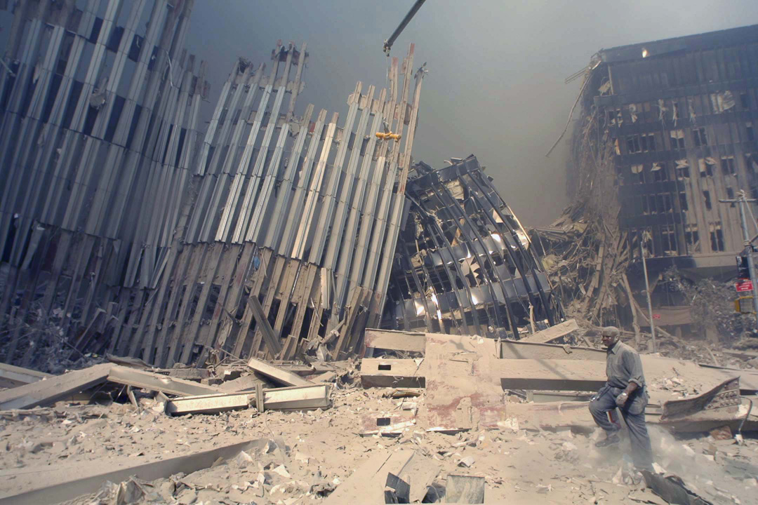 A survivor of the 1st tower collapse walks by the 107th floor