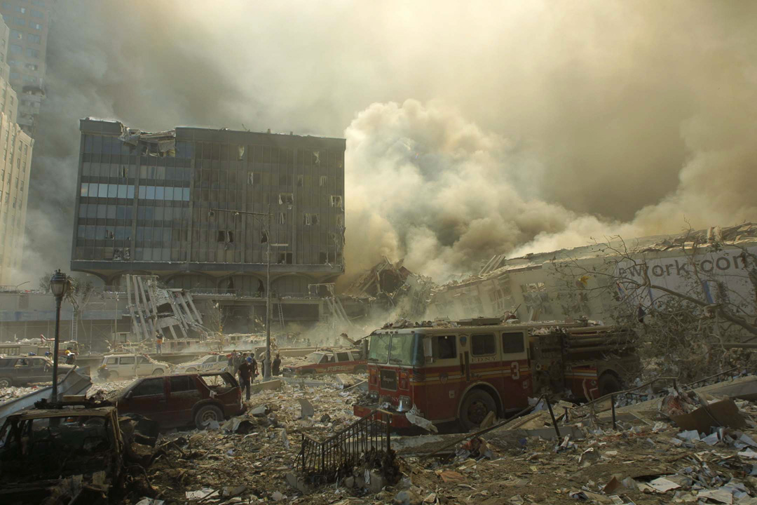 Smoke pours from the collapsed WTC on West St.