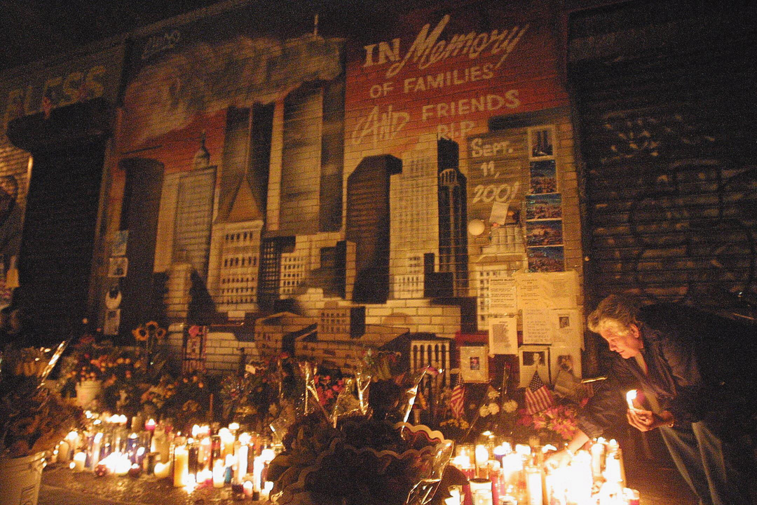 A candelight vigil illuminates a new mural in memory of 9/11